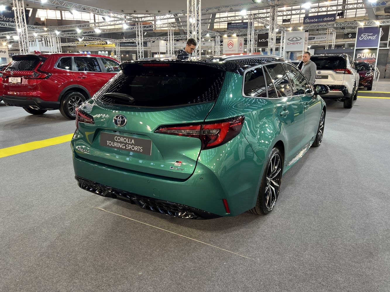Sporty green hatchback with LED tail lights and alloy wheels