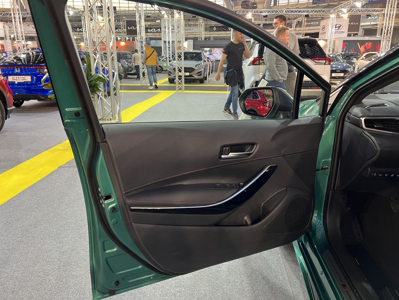 Black interior door panel with chrome accents and window controls.