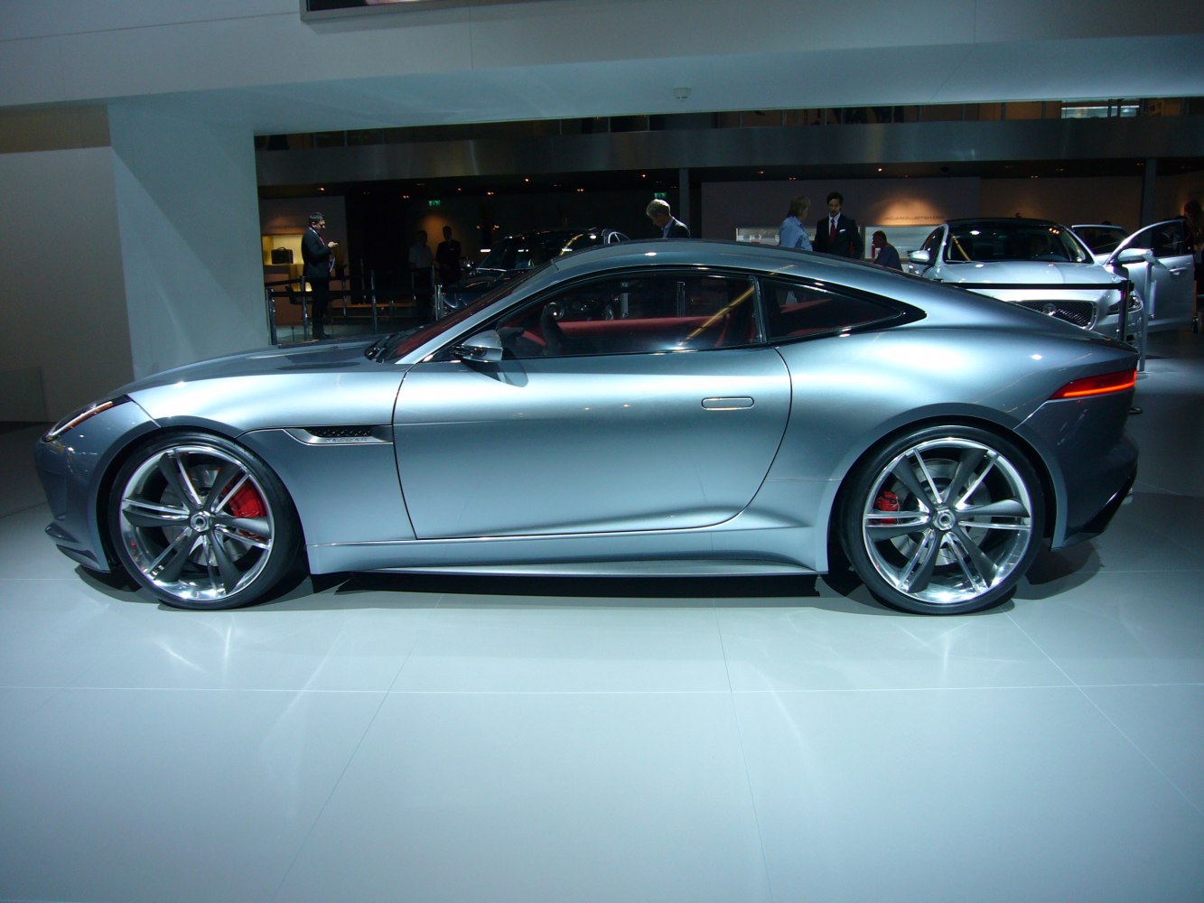 Silver sports coupe with large alloy wheels and red brake calipers.