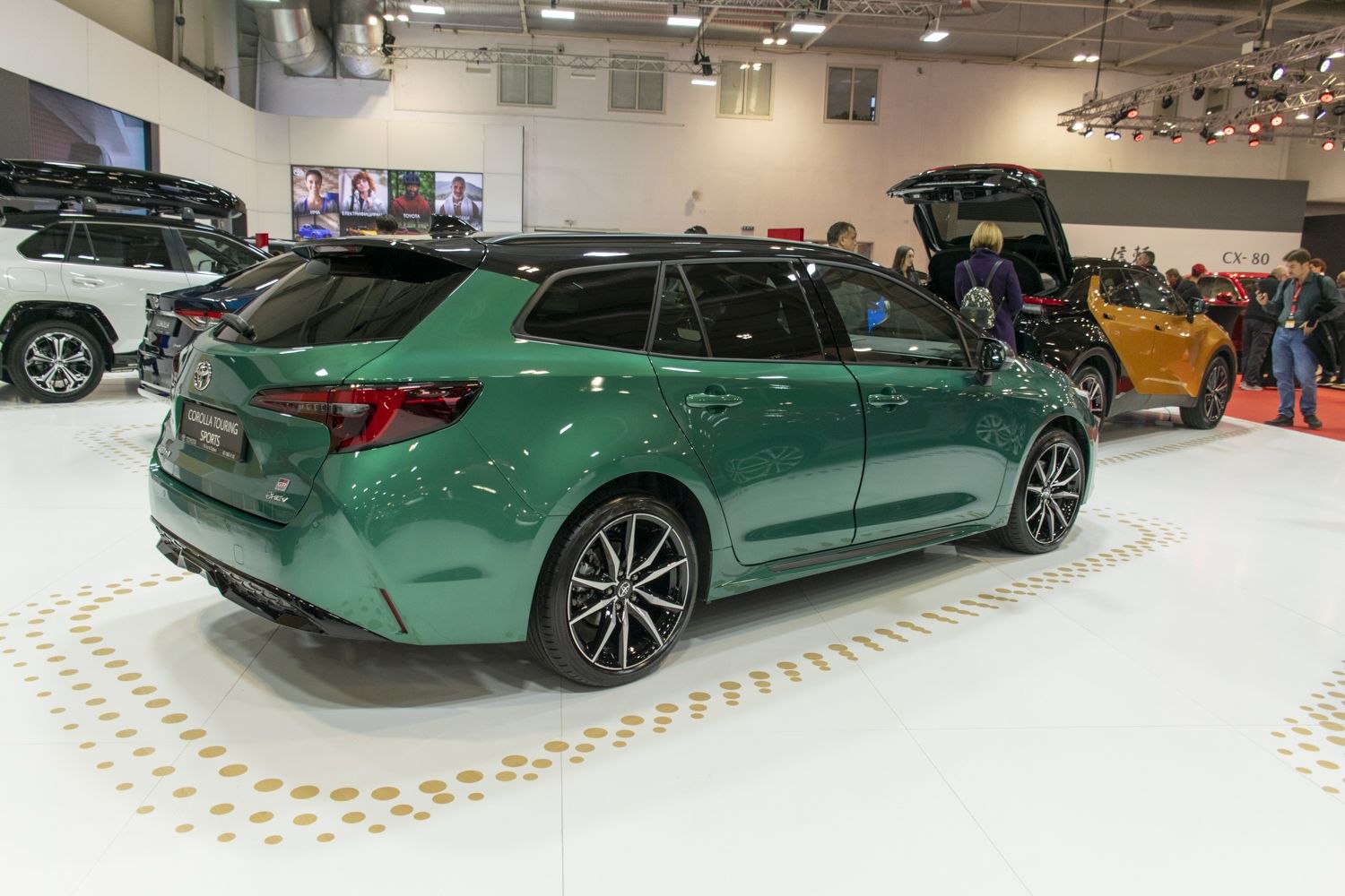 Sleek rear side view of green station wagon with alloy wheels