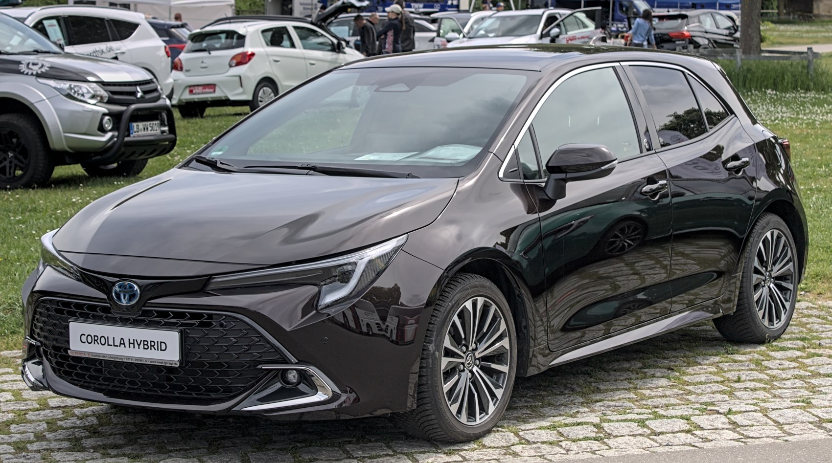 Front view of a sleek hybrid hatchback with distinctive grille and LED headlights