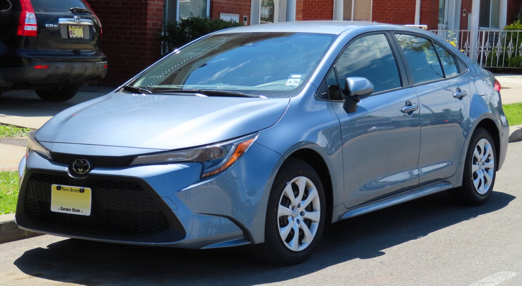 Front and side angle view of a modern sedan with aerodynamic design