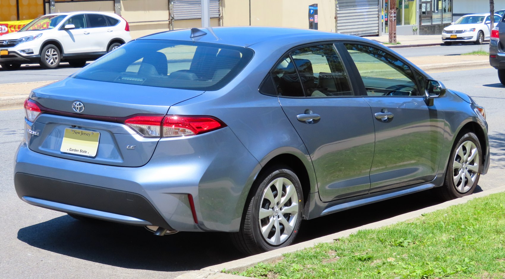 Rear side view of a mid-size sedan with modern taillights and aerodynamic body design