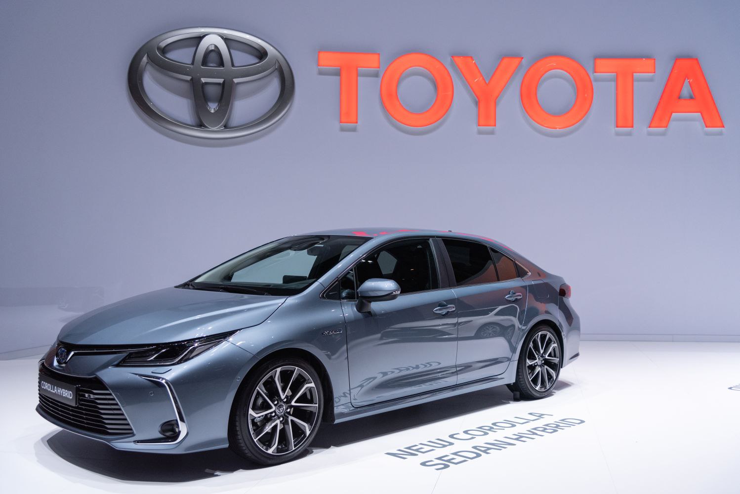 Front side view of a sleek hybrid sedan with modern headlights and alloy wheels