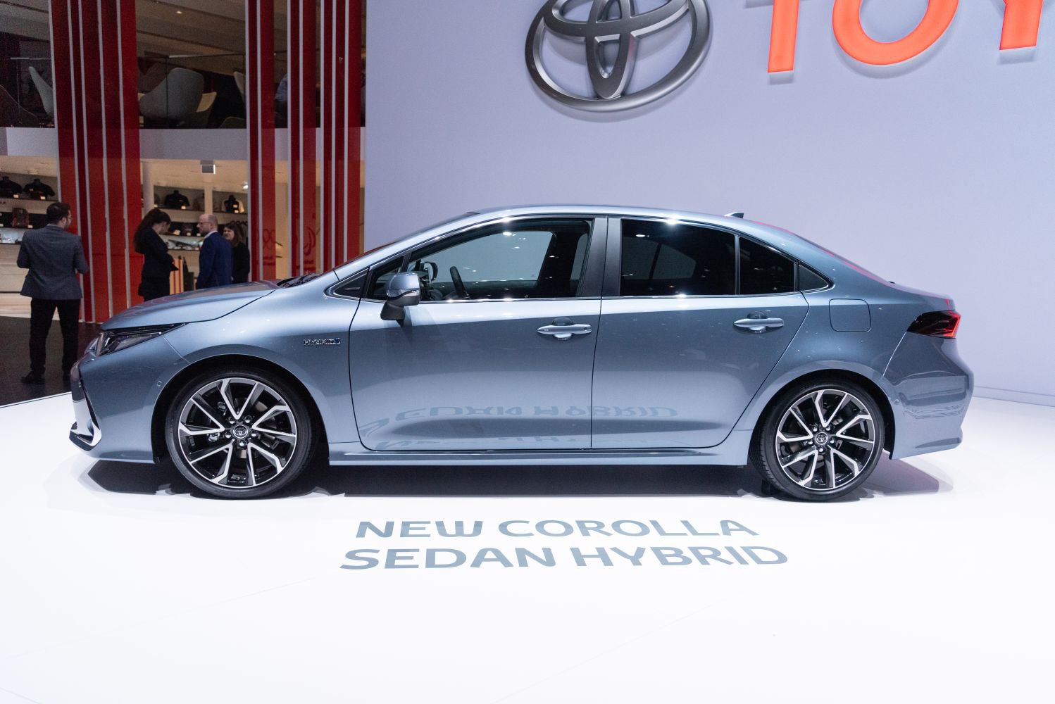 Side profile of a hybrid sedan with sporty alloy wheels