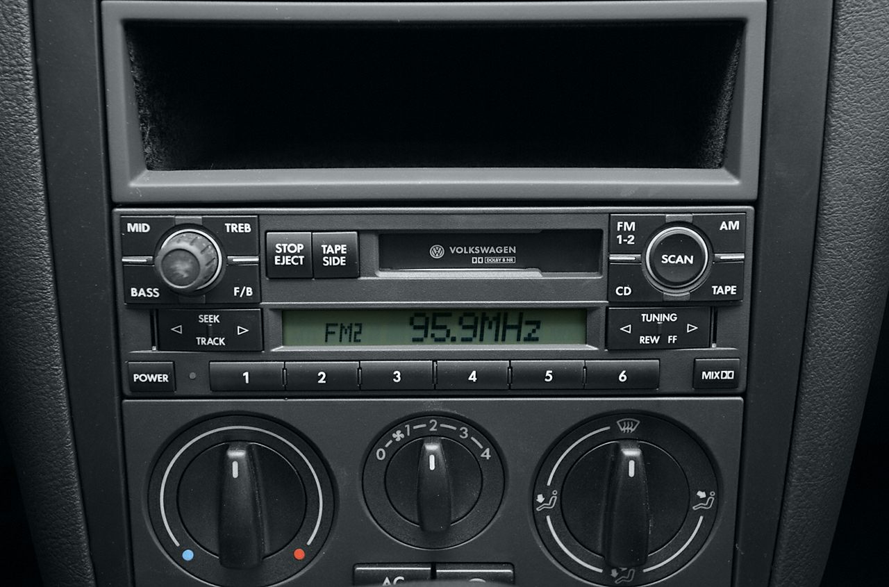 Car audio system and climate control knobs with cassette player and radio display.