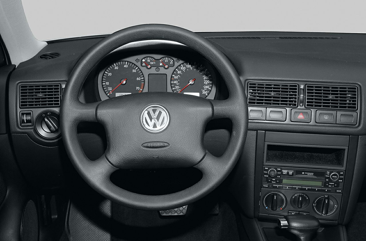 Volkswagen-style steering wheel and dashboard with analog gauges and air vents