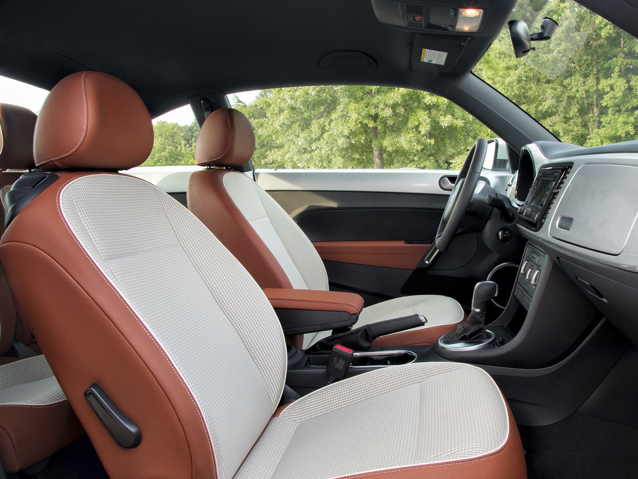Two-tone brown and white seats with sleek dashboard and gearshift.