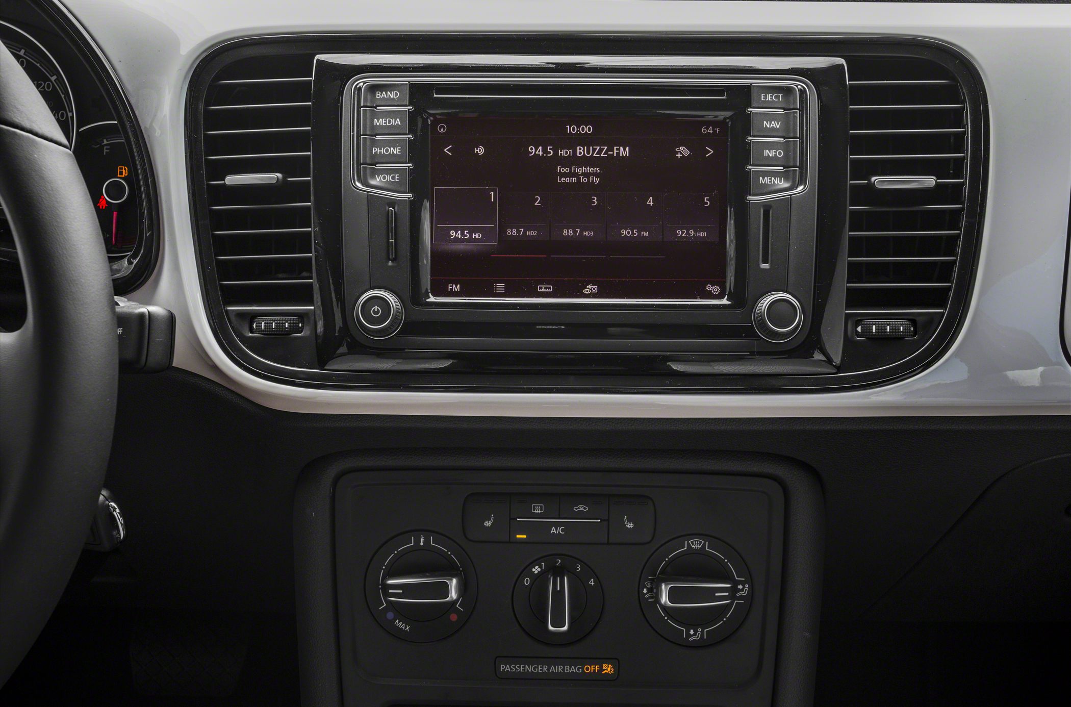Infotainment system and manual climate controls with knobs and buttons
