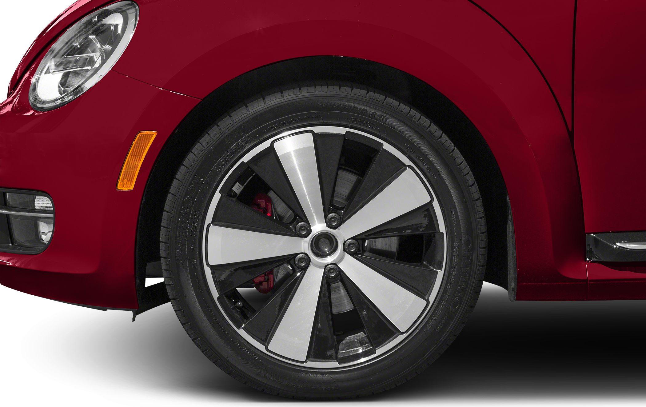 Close-up of multi-spoke alloy wheel and red front fender.