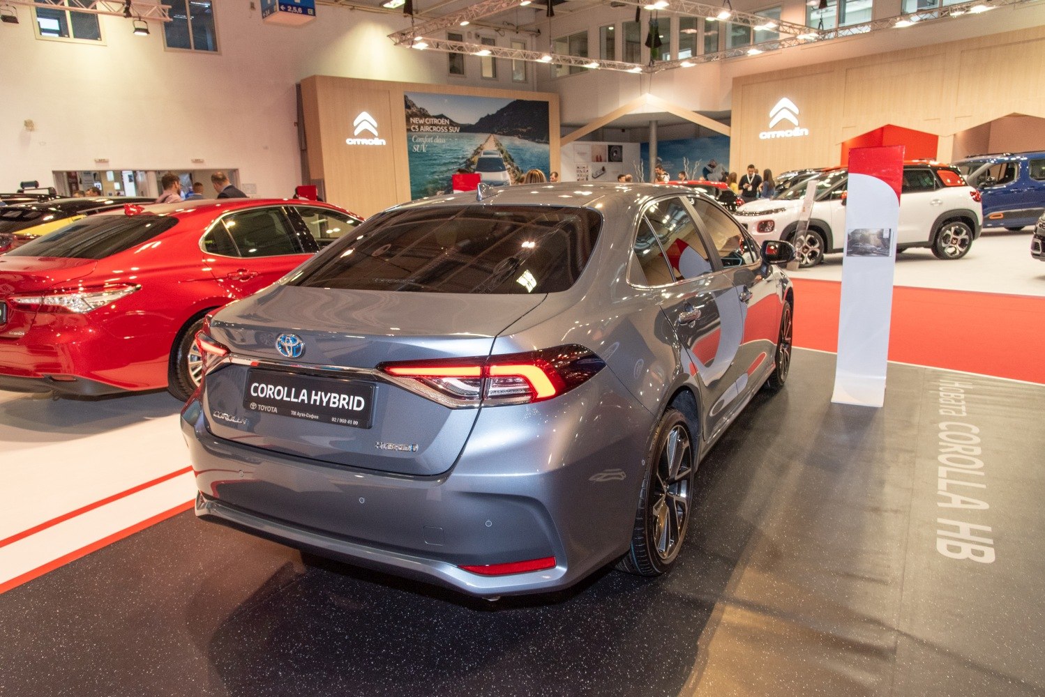 Rear view of a modern hybrid sedan with LED taillights and alloy wheels