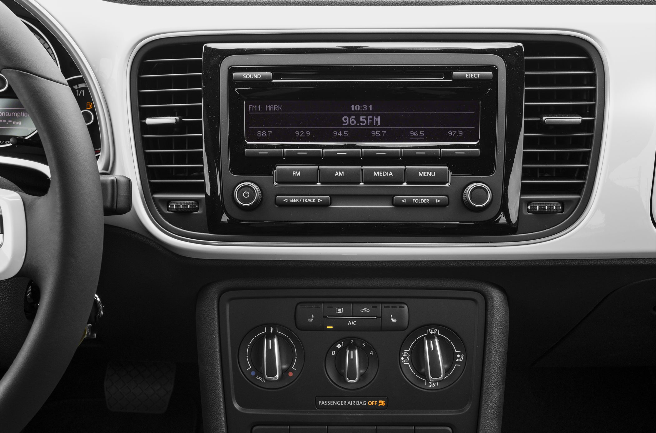 Car dashboard with radio and manual climate controls