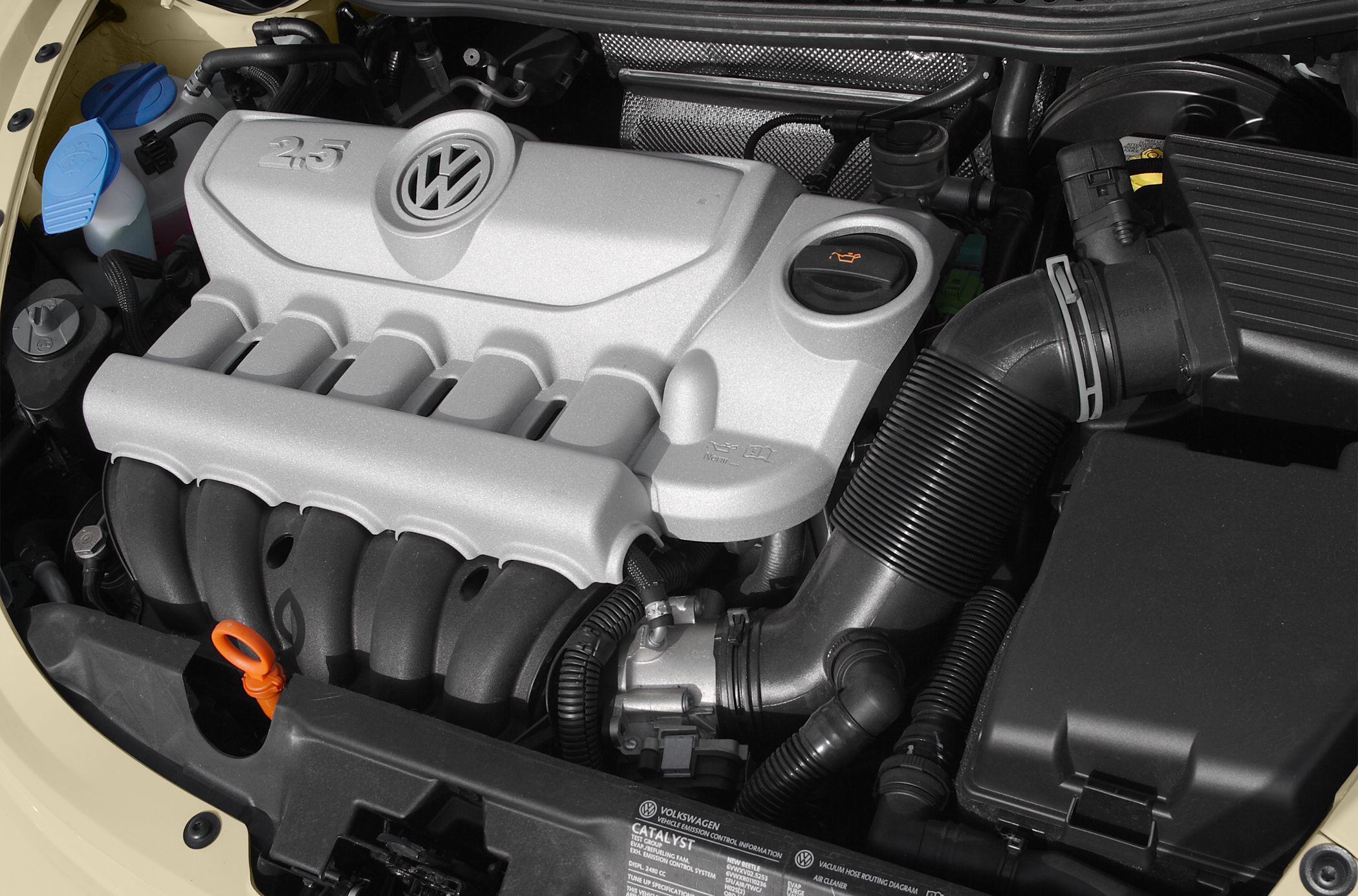 Close-up of a 2.5L Volkswagen engine bay with visible oil cap and air intake.