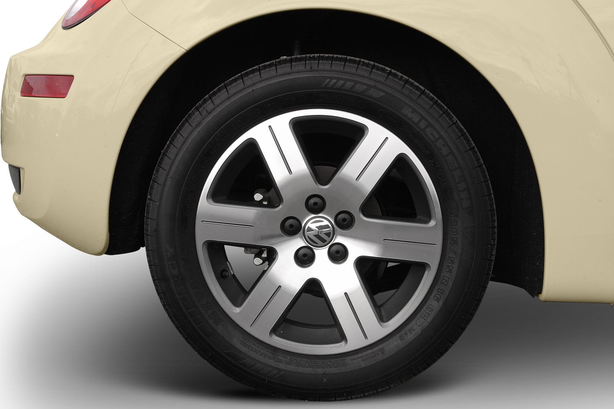 Alloy wheel with Volkswagen logo and Michelin tire on beige car body