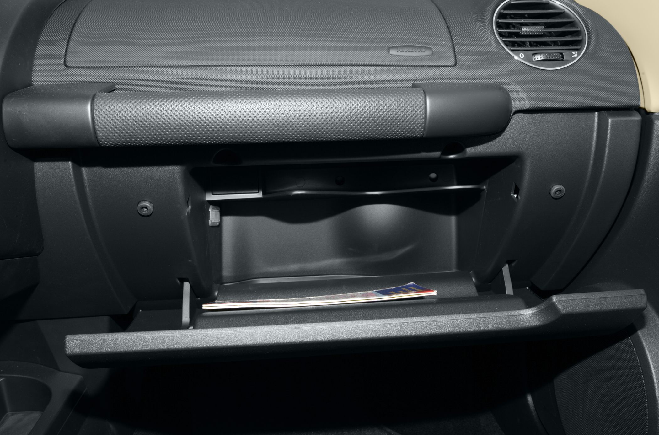 Open glove compartment inside a car dashboard