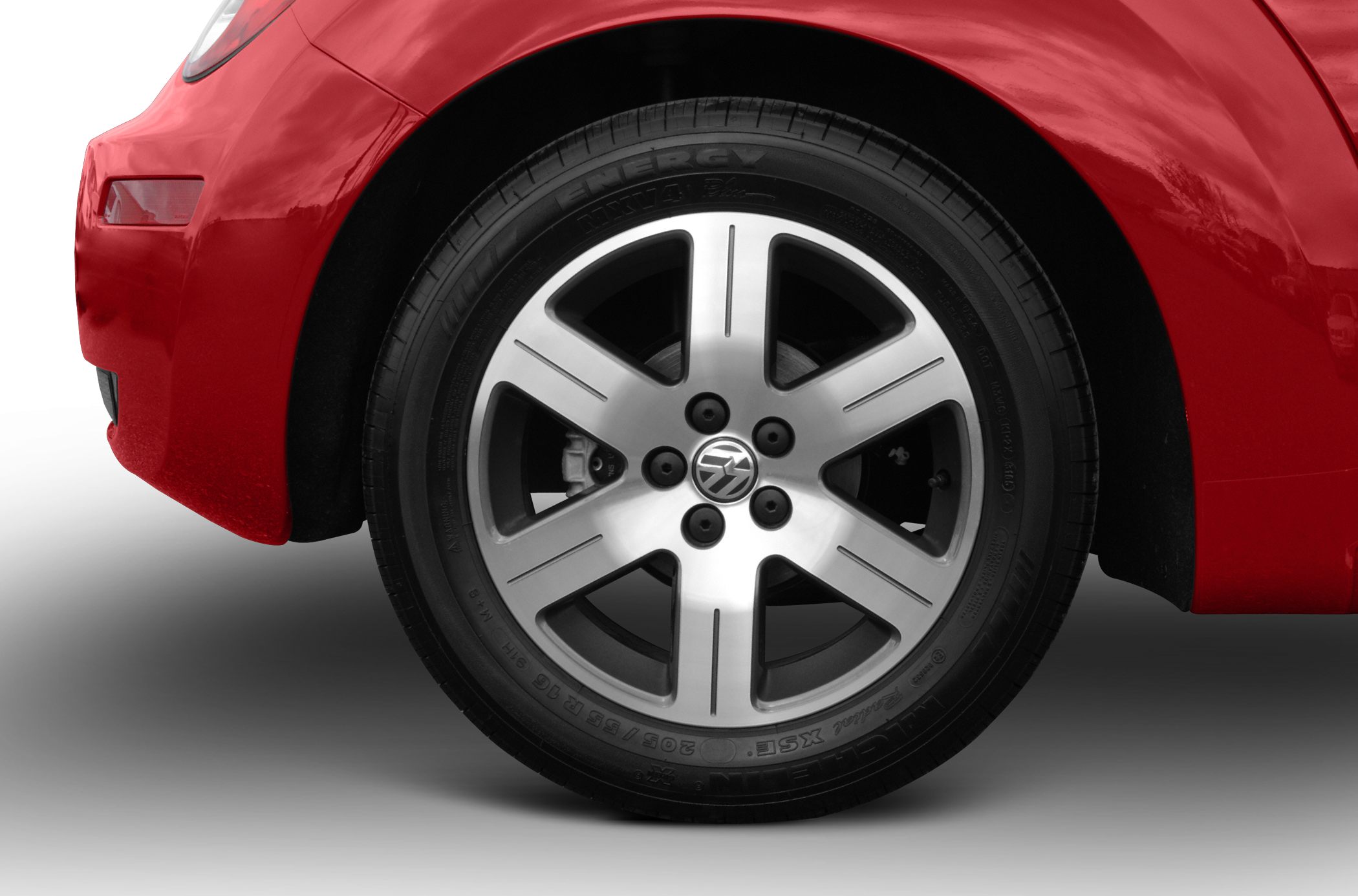 Close-up of alloy wheel with red car fender