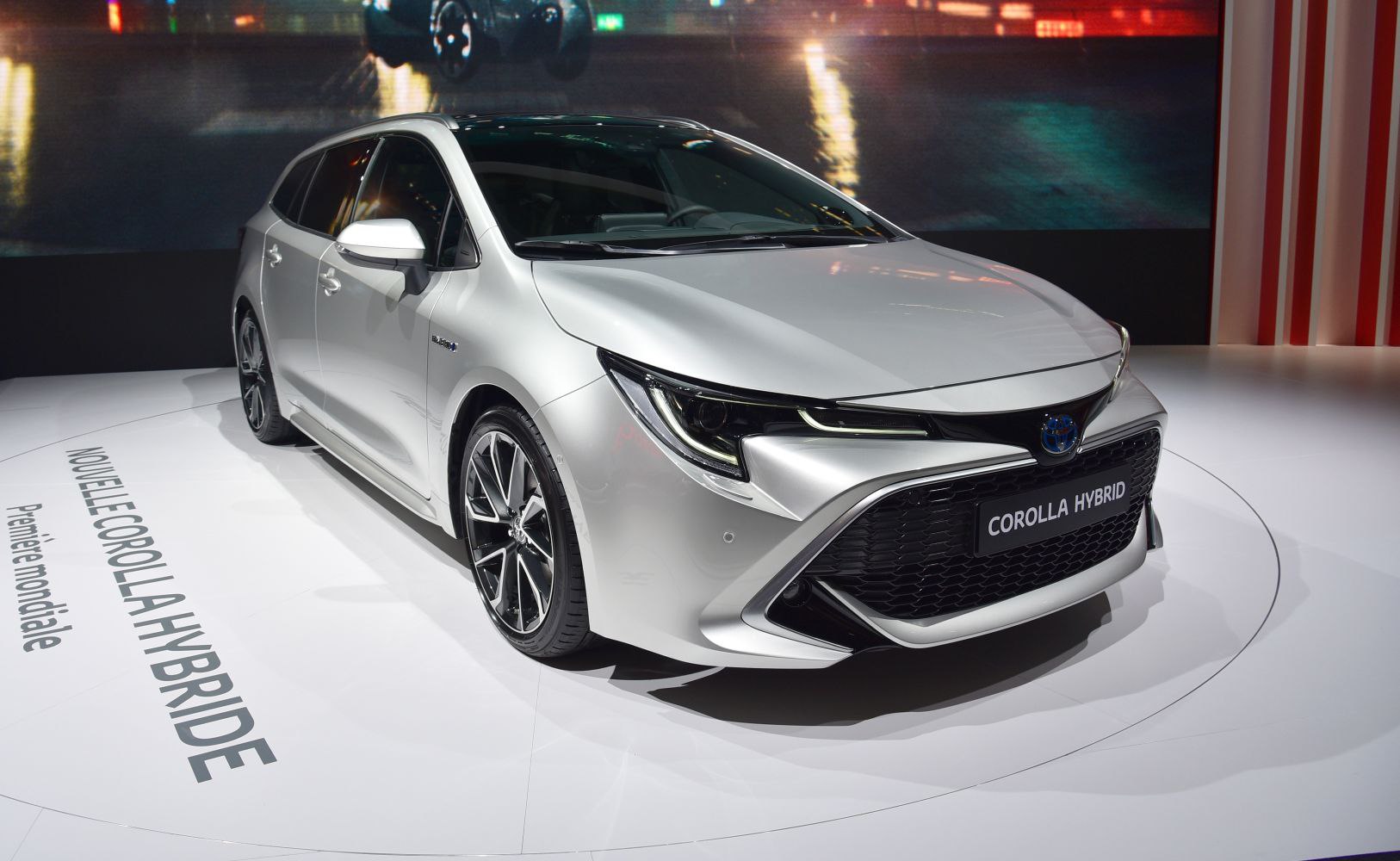 Silver modern hatchback with LED headlights and sporty mesh grille