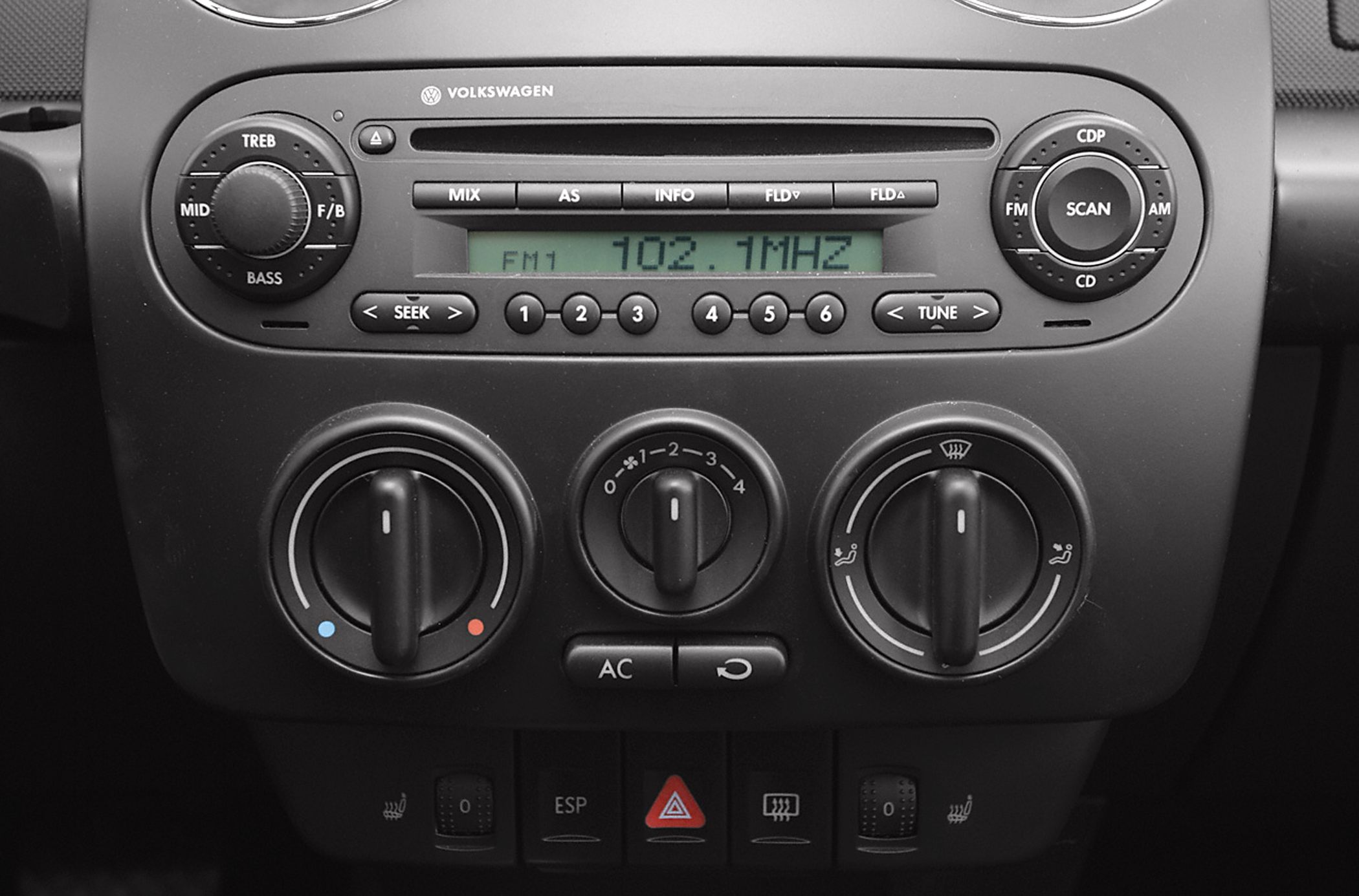 Car radio and climate control knobs with adjustment dials and buttons.