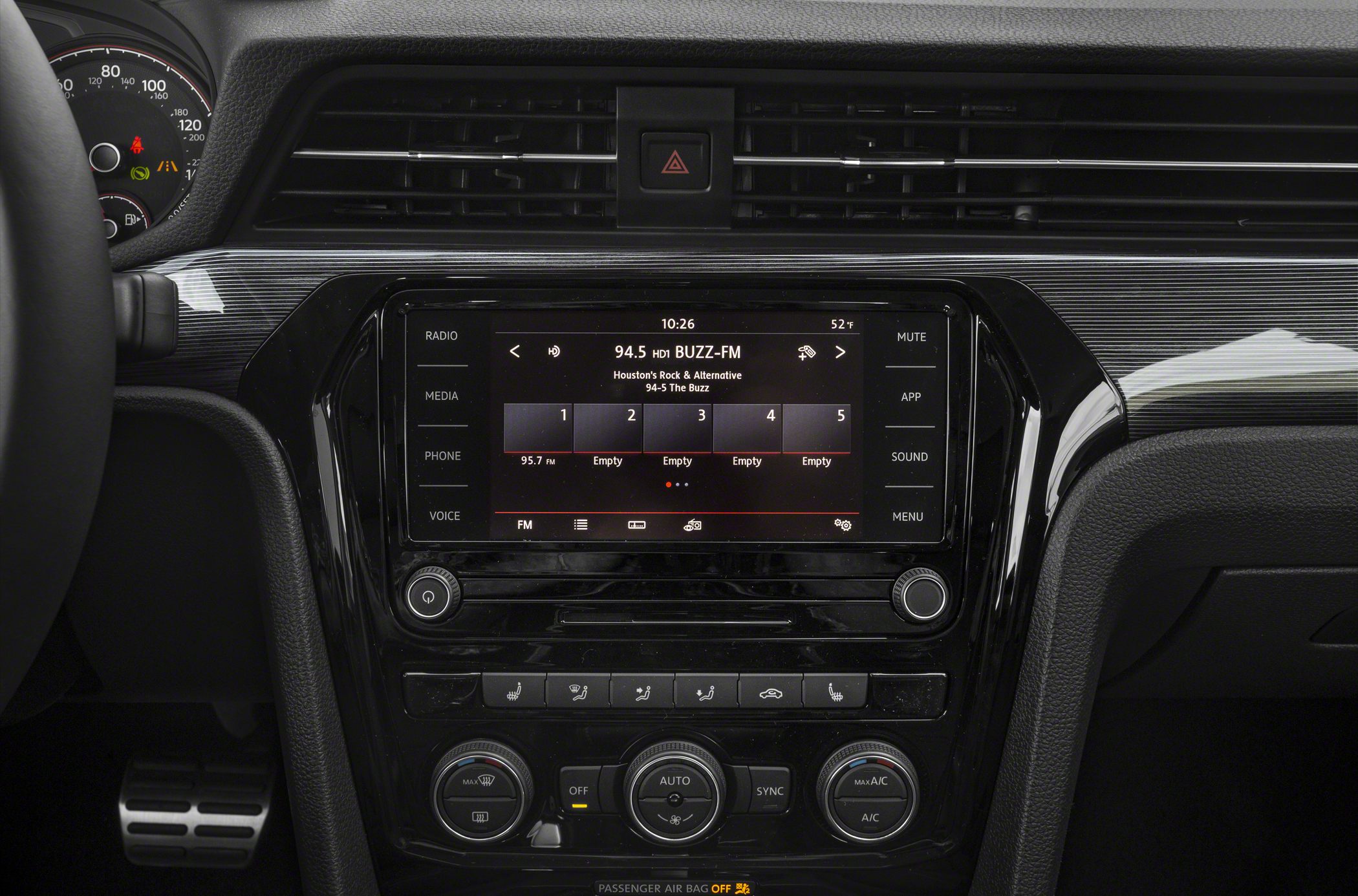 Infotainment touchscreen with climate control dials and buttons in a car dashboard