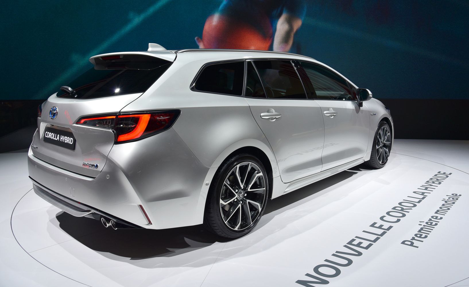 Rear side view of hybrid station wagon with modern tail lights and sporty wheels