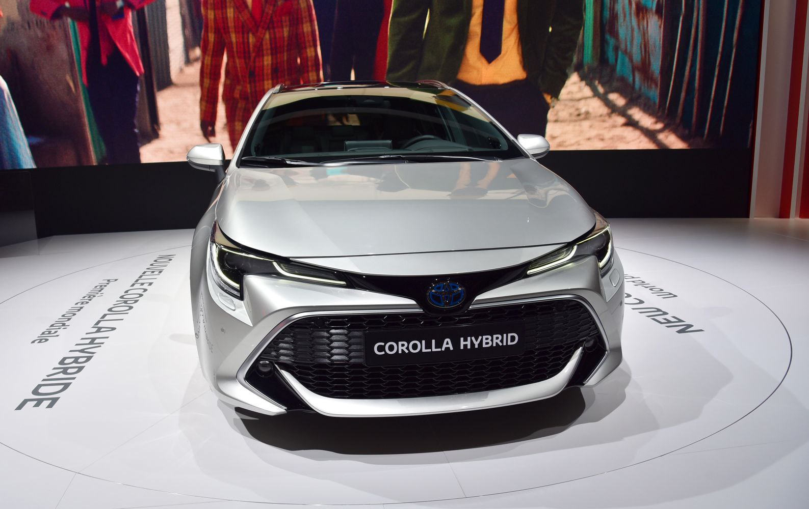 Sleek headlights and large front grille of a hybrid vehicle