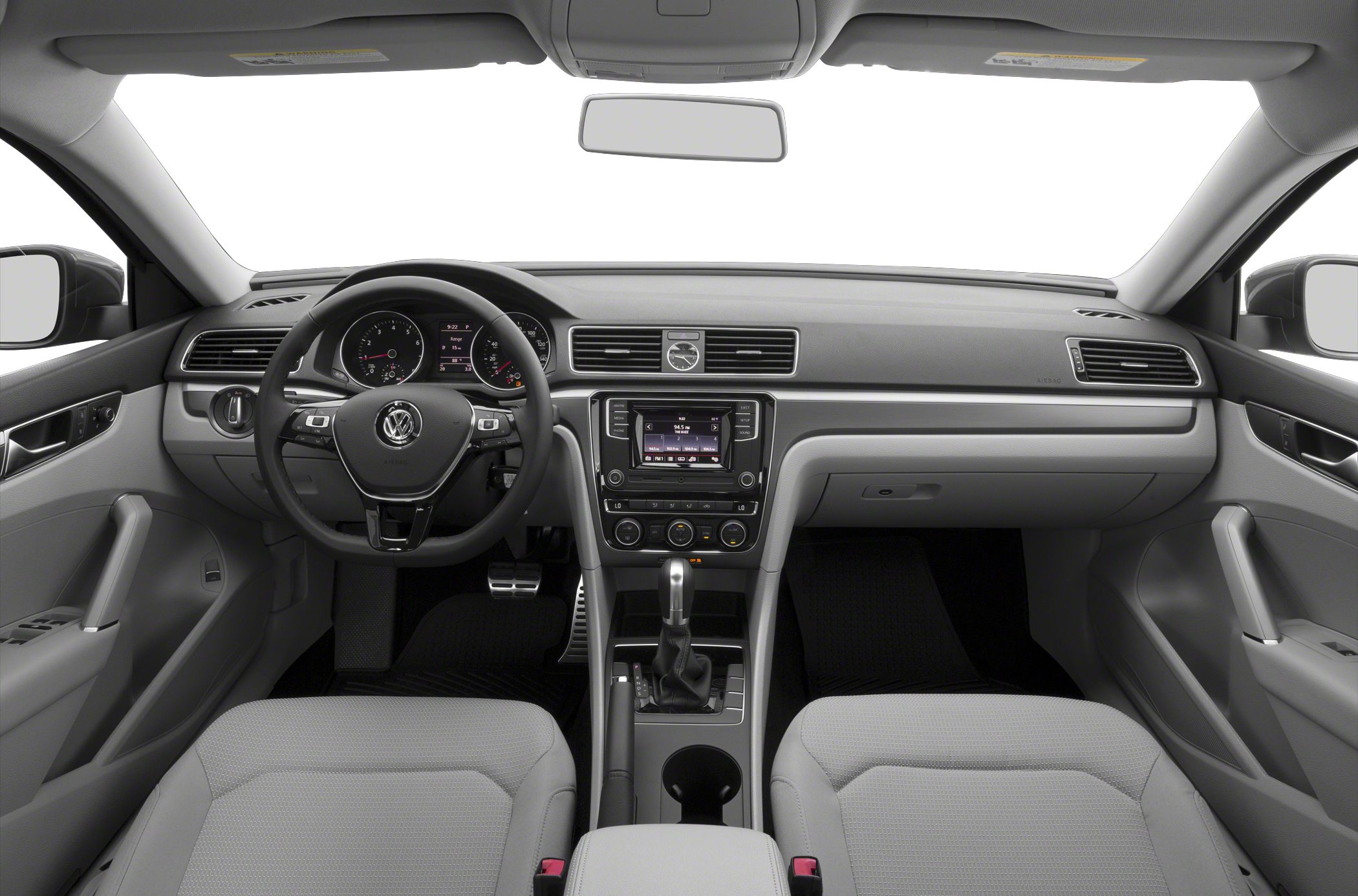 Modern dashboard, steering wheel, central console, and front seats.