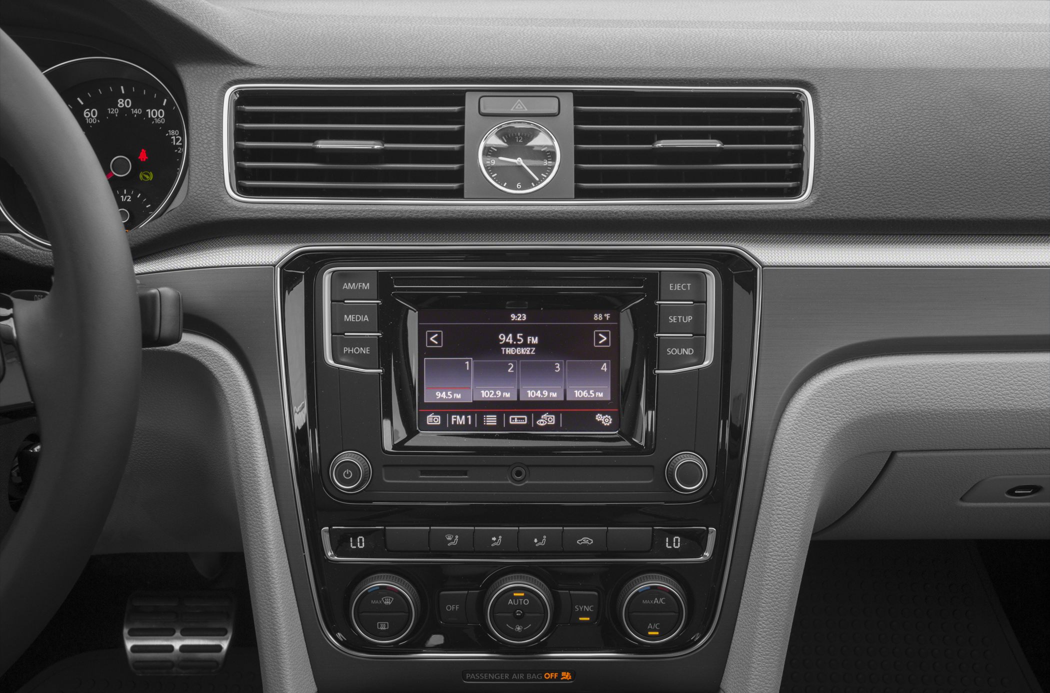 Central dashboard with infotainment system and analog clock