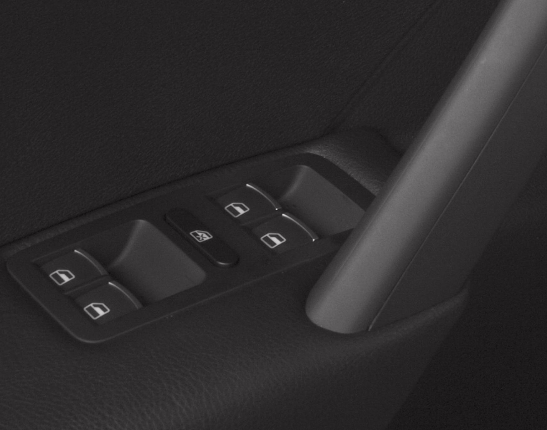 Electric window switches and lock button on car door panel