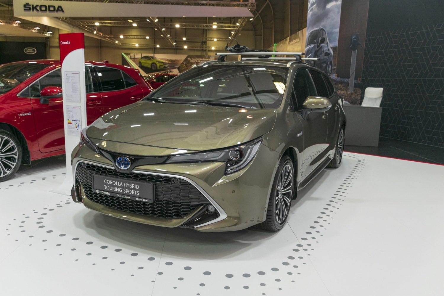 Front view of modern hybrid station wagon with roof rails and LED headlights