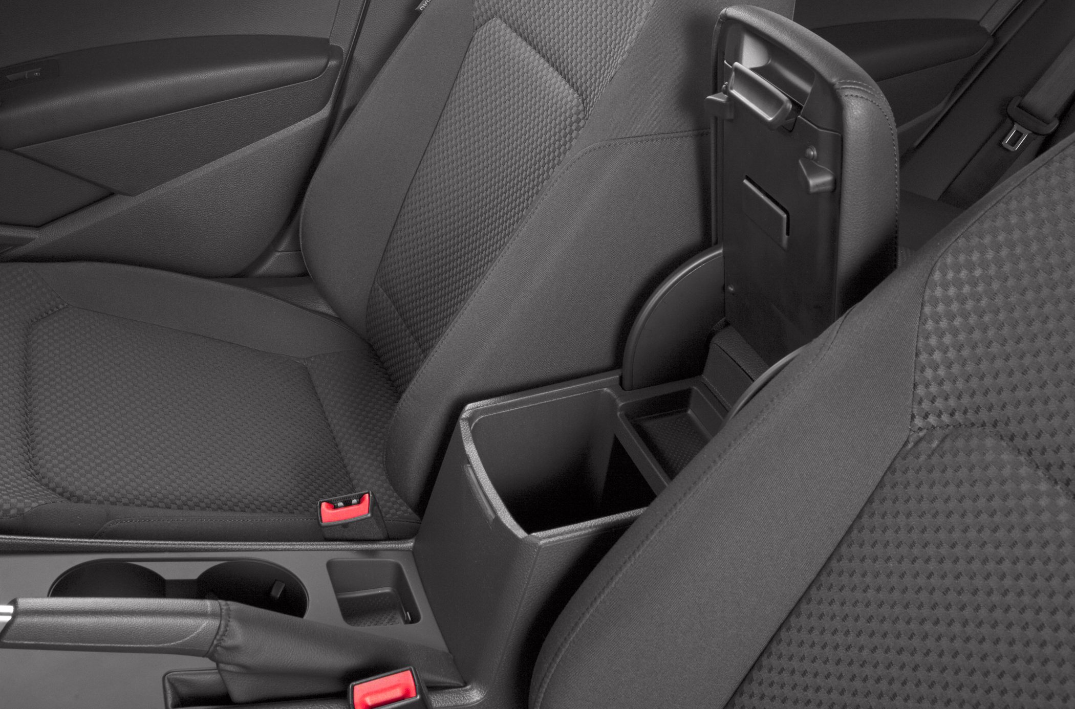 Open center console storage with black textured seats