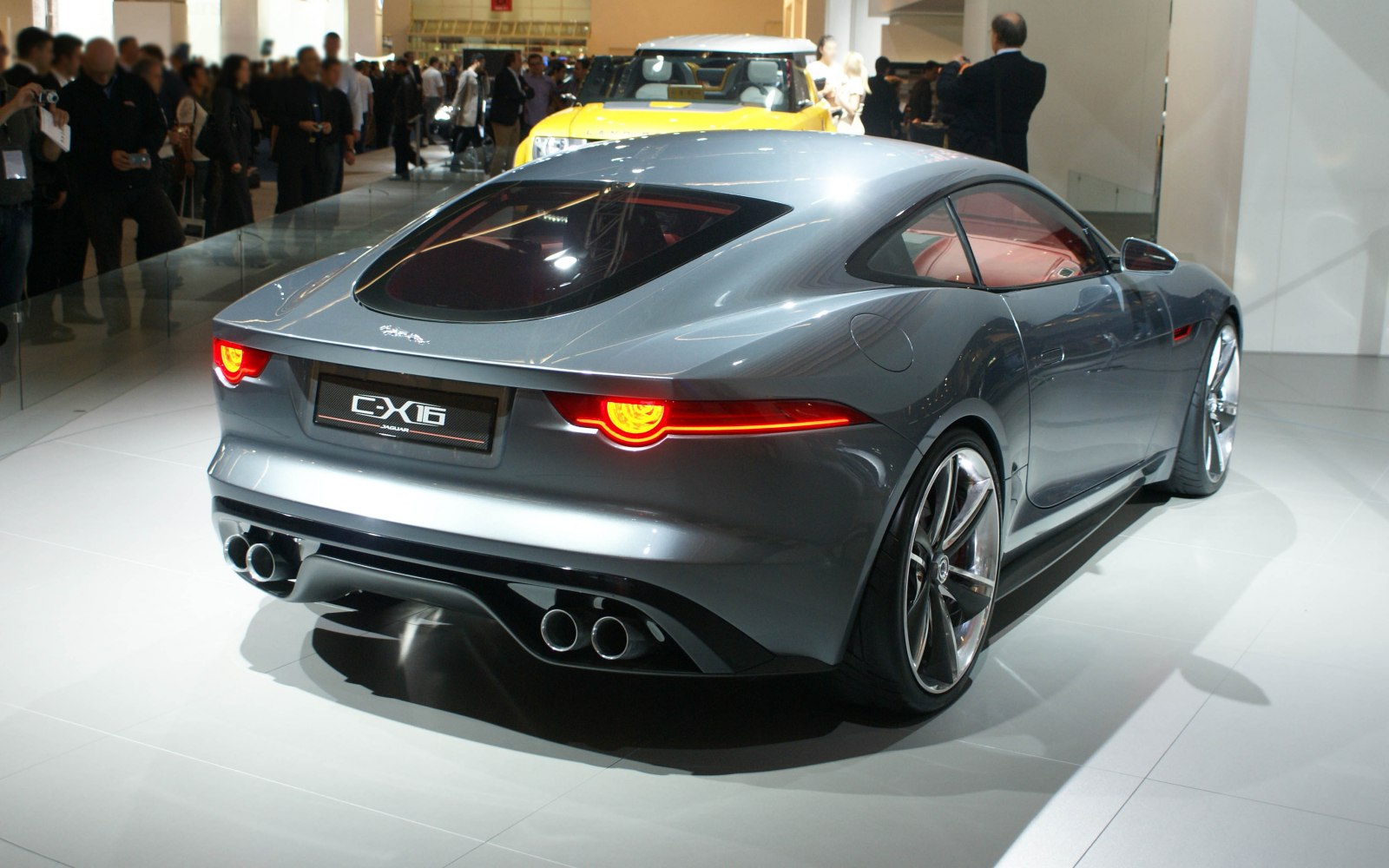 Rear view of a sleek silver sports coupe with LED tail lights and quad exhausts