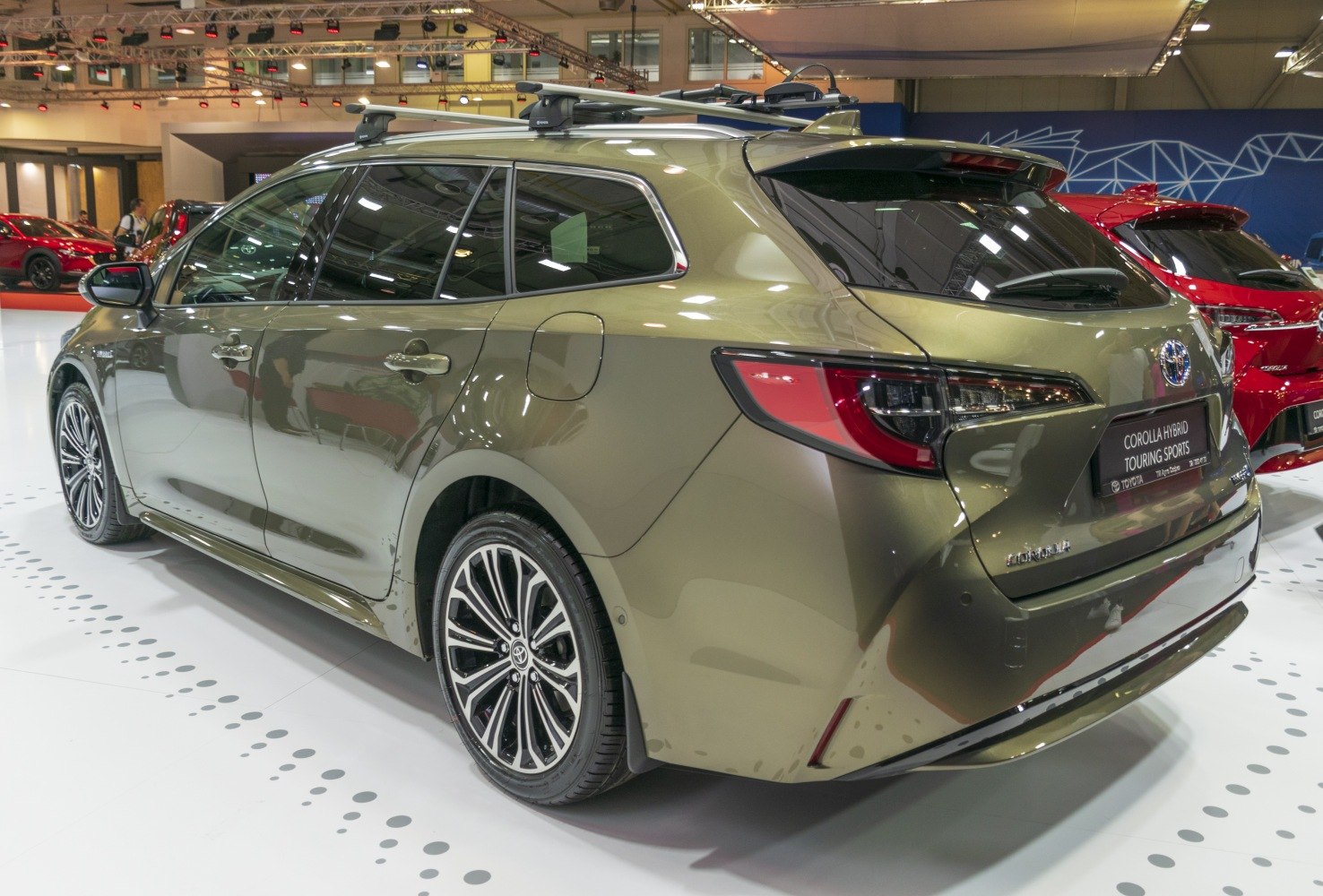 Rear and side view of hybrid station wagon with roof rack and alloy wheels