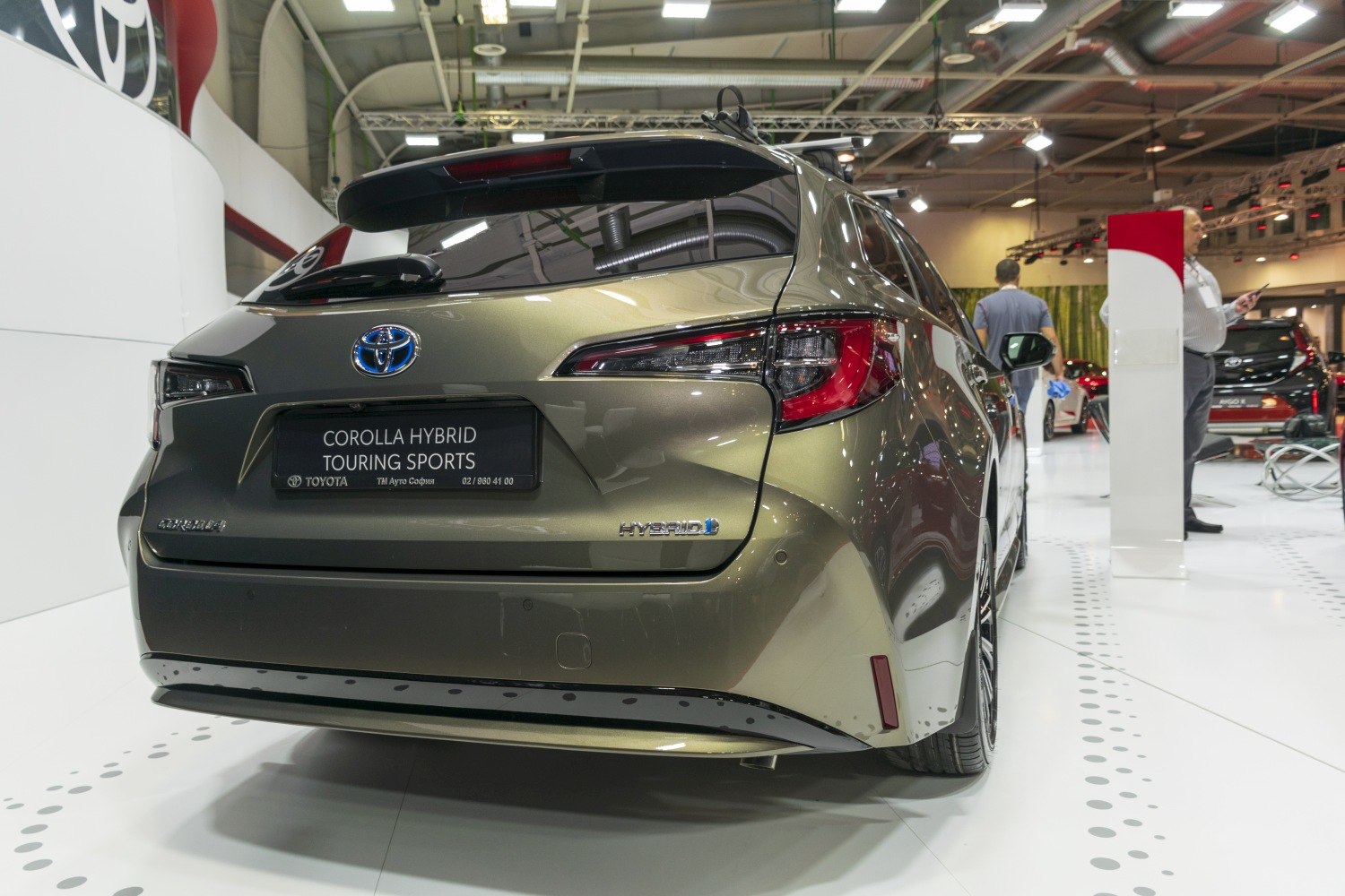 Hybrid hatchback rear view with modern taillights and spoiler.