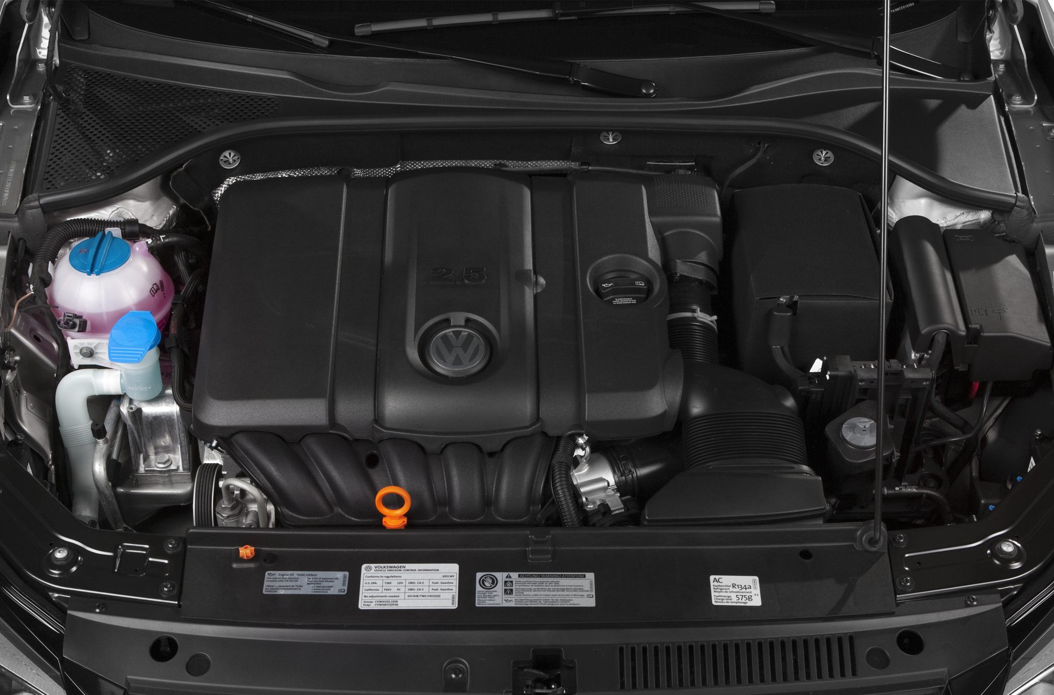 Close-up of 2.5L engine compartment with cover, coolant and oil caps