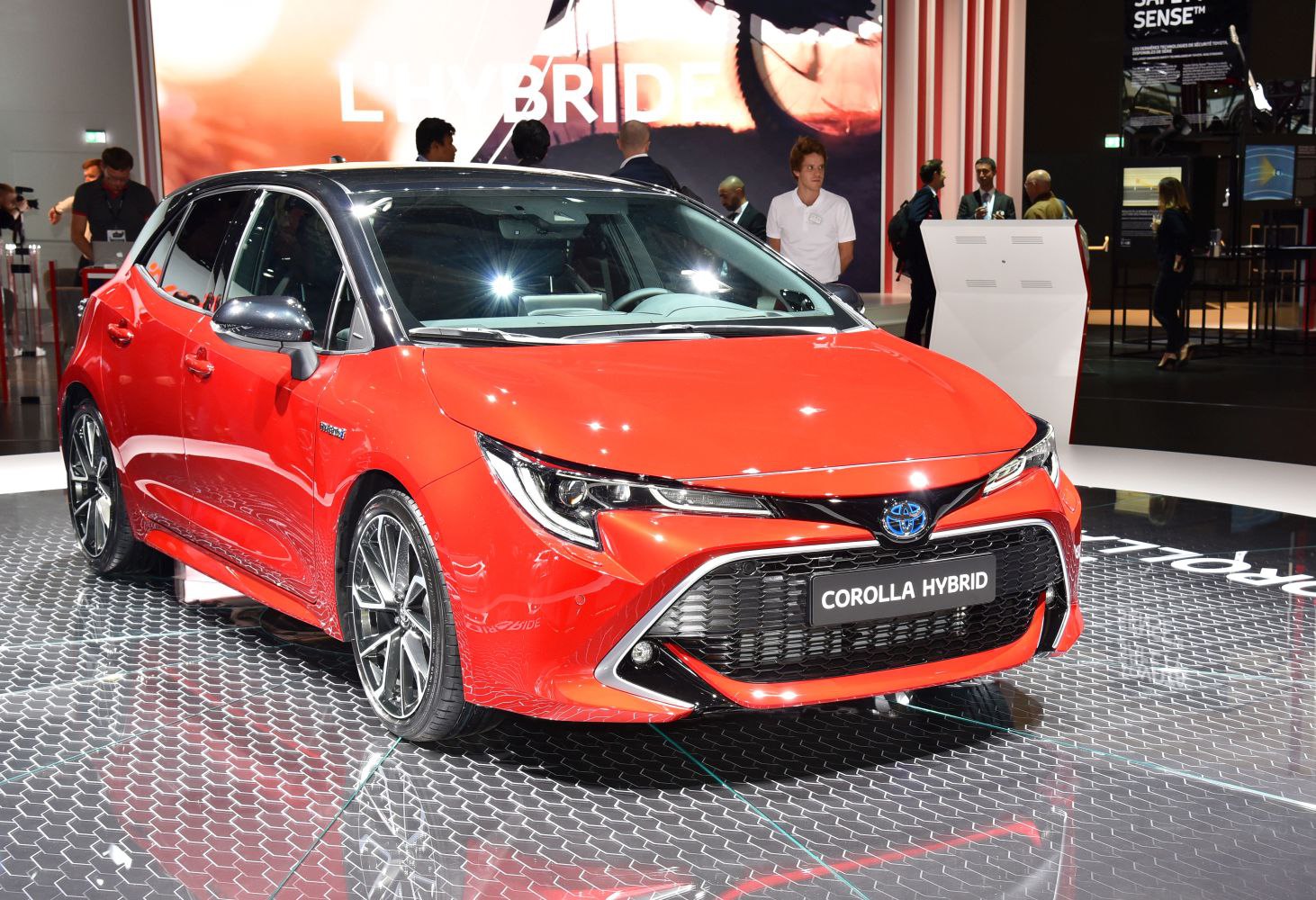 Front view of sporty red hatchback with distinctive LED headlights and alloy wheels.