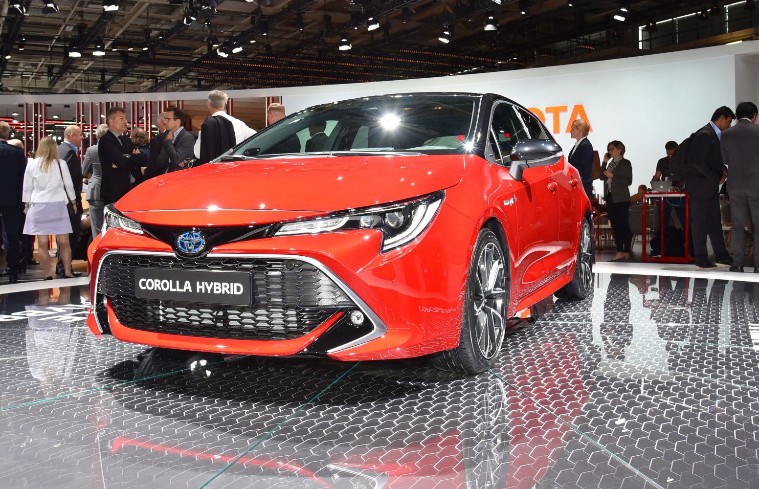Red hatchback with sporty front grille and LED headlights
