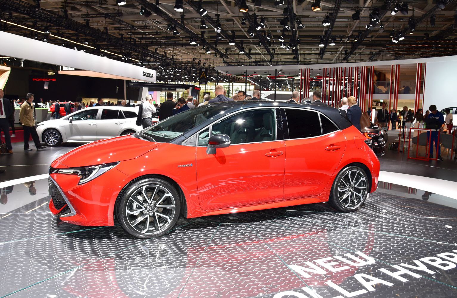 Red and black two-tone hybrid hatchback with sporty alloy wheels