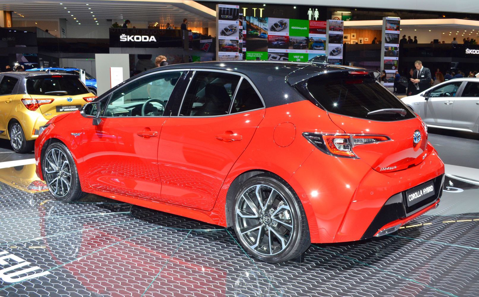 Red hatchback with black roof and alloy wheels