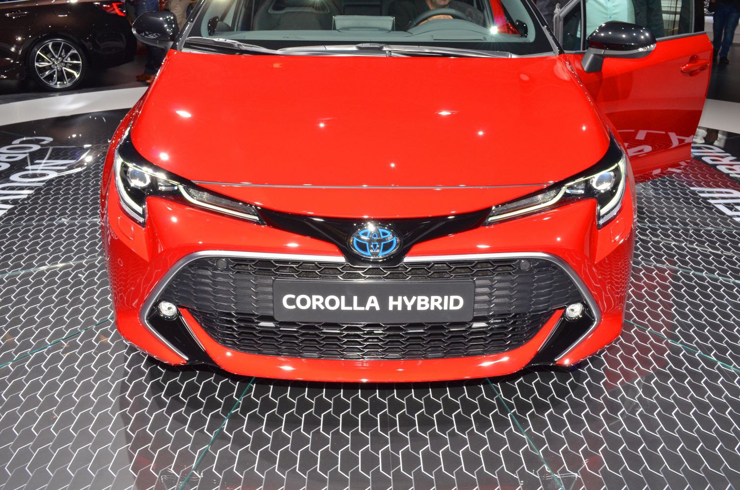 Front view with hybrid badge and aggressive headlights
