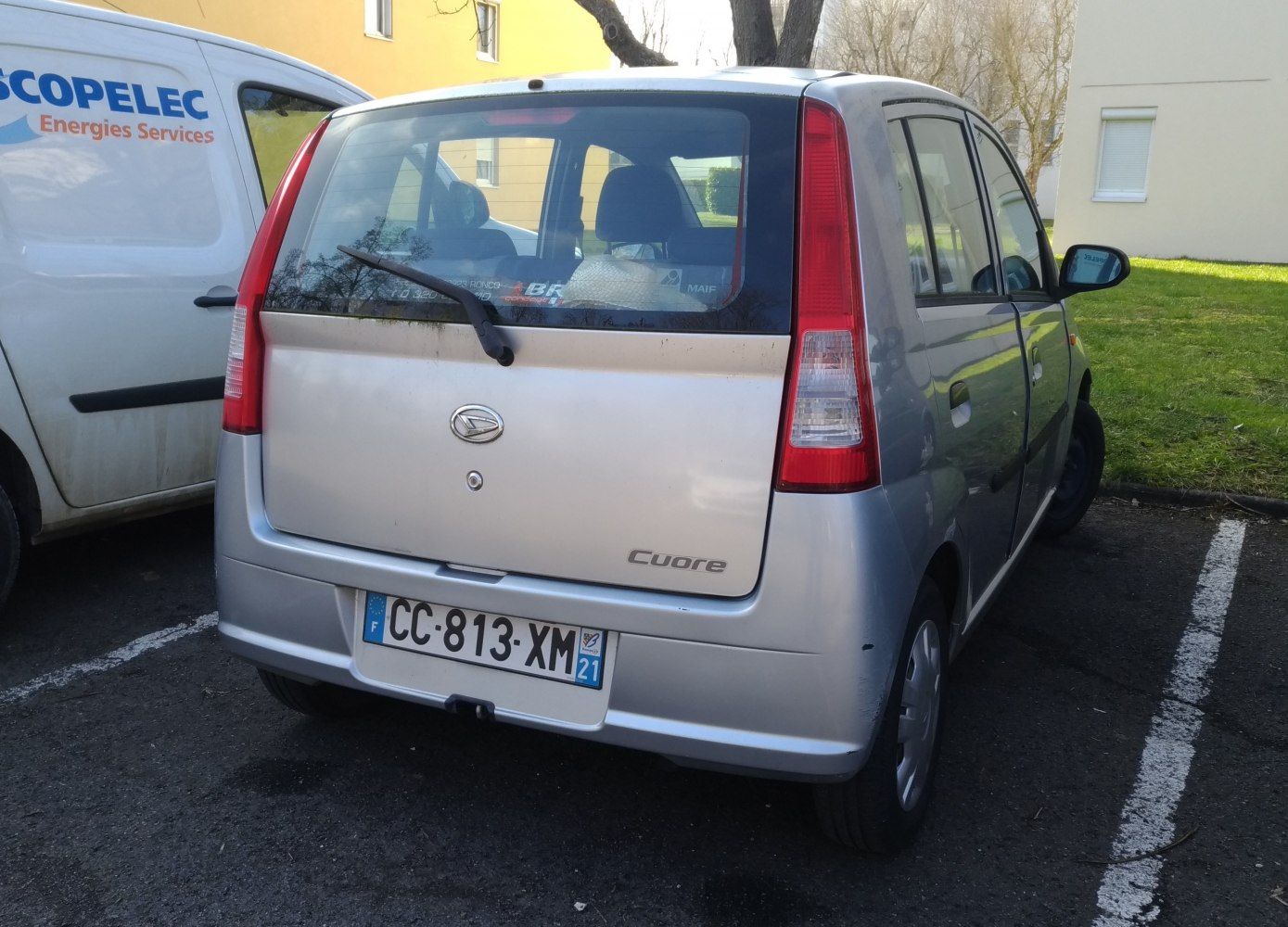 Compact hatchback rear view with vertical taillights and rear windshield wiper