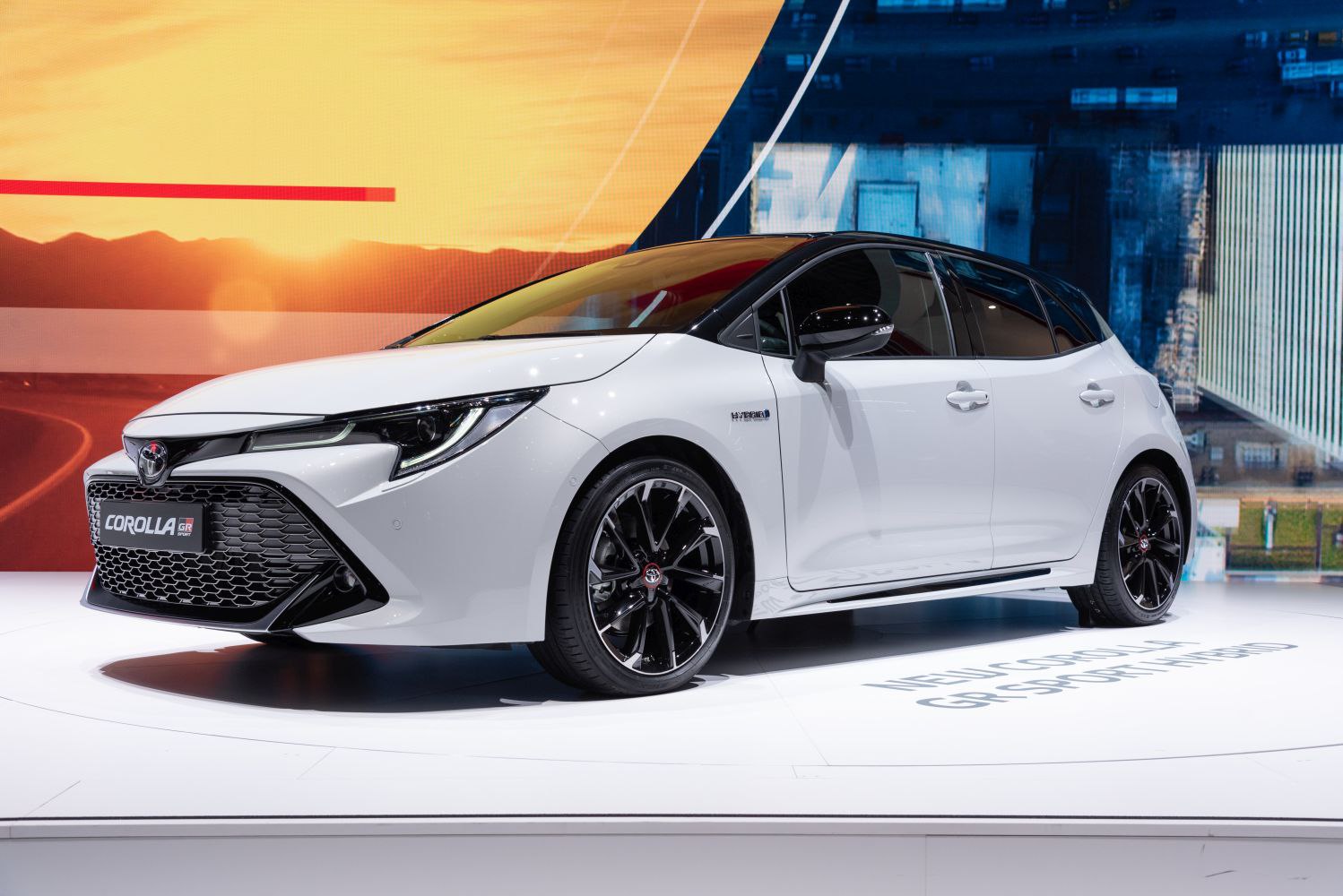 Sporty hatchback front side view with hybrid badge and black alloy wheels