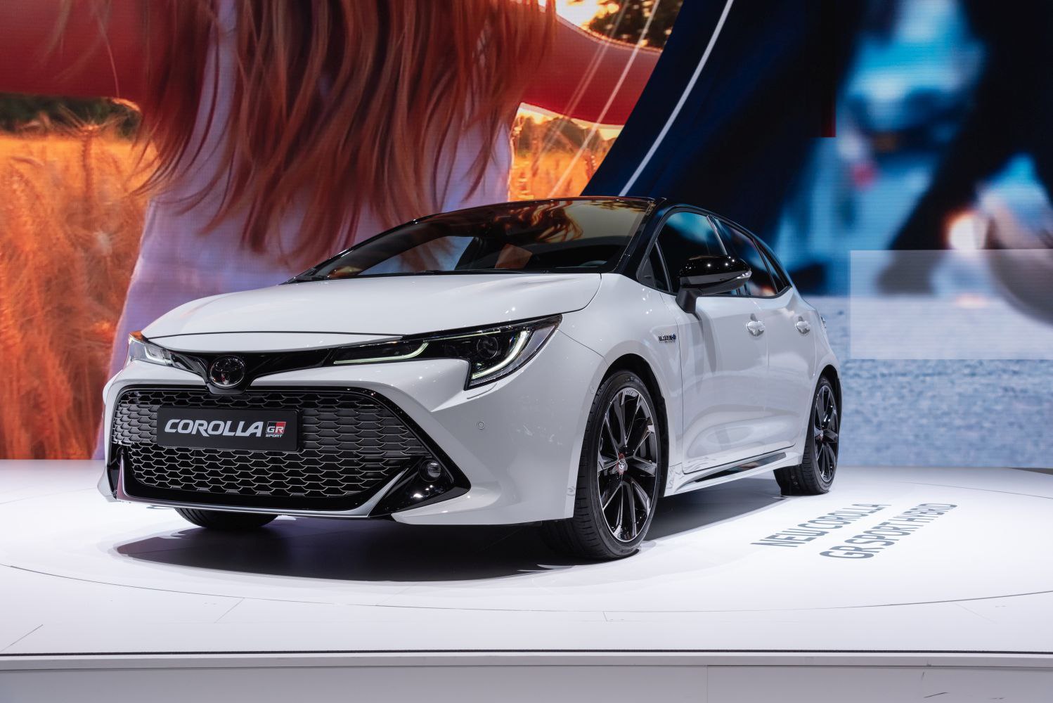 Sporty hatchback front angle with LED headlights and large grille