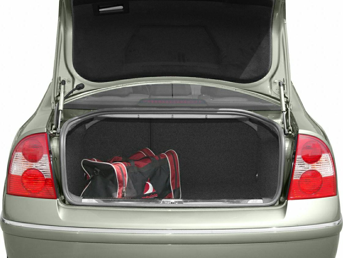 Open rear trunk with duffel bag inside and visible taillights
