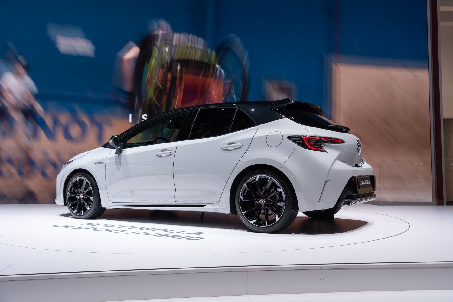 Sporty hybrid hatchback side profile with black roof and alloy wheels