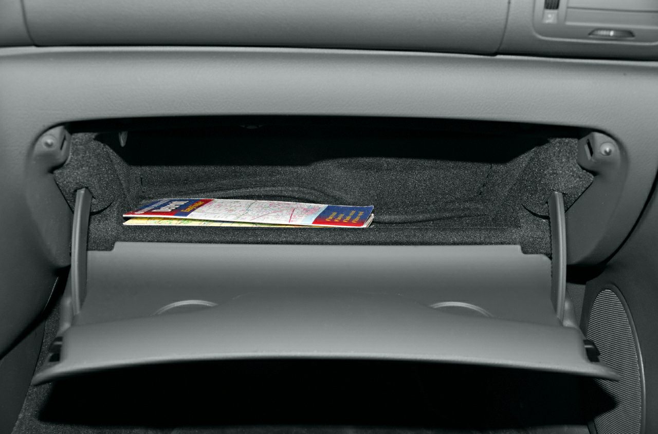 Open glove compartment with interior storage and folded map