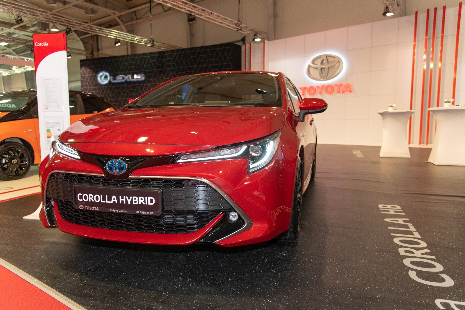 Front view with hybrid badge, sleek LED headlights, and bold grille