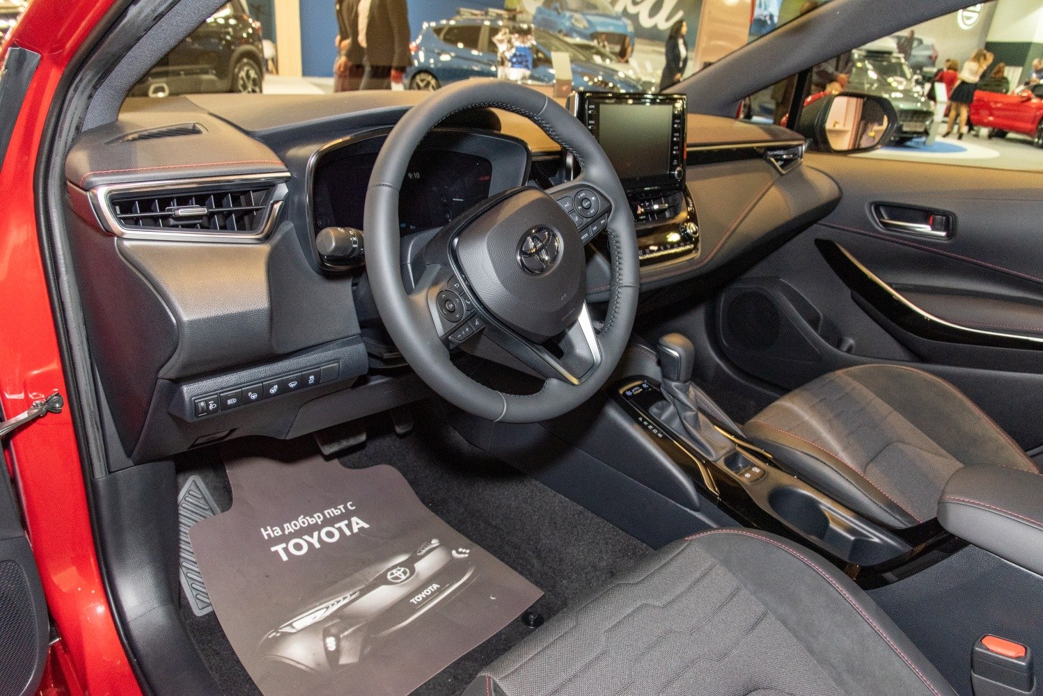 Steering wheel with controls, digital dashboard, touchscreen display, and center console