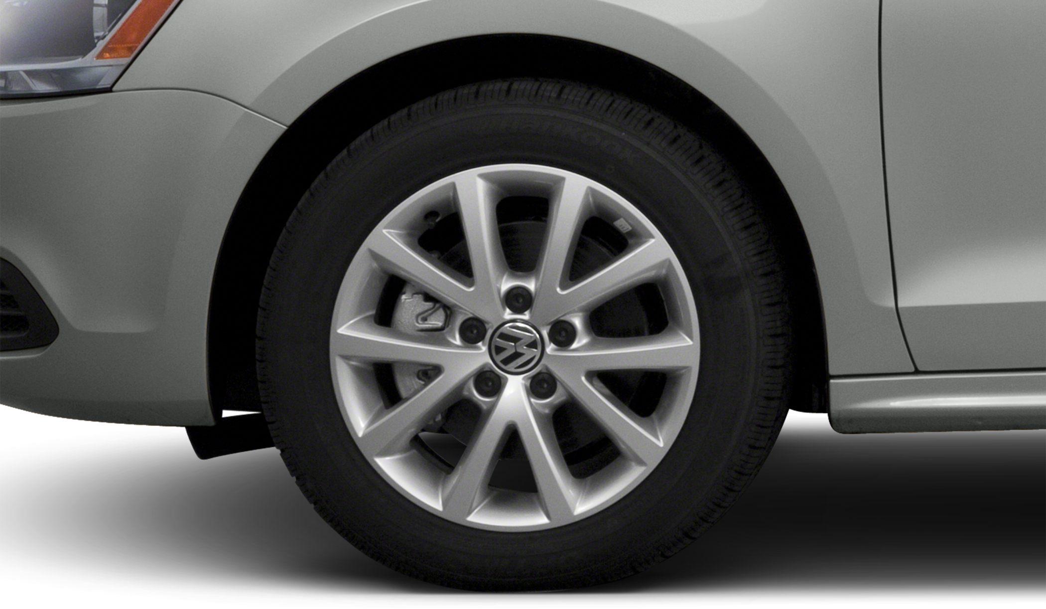 Close-up of a silver alloy wheel with dual-spoke design and visible brake caliper.