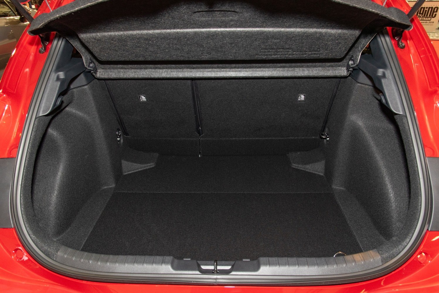Spacious hatchback trunk interior with black carpeting