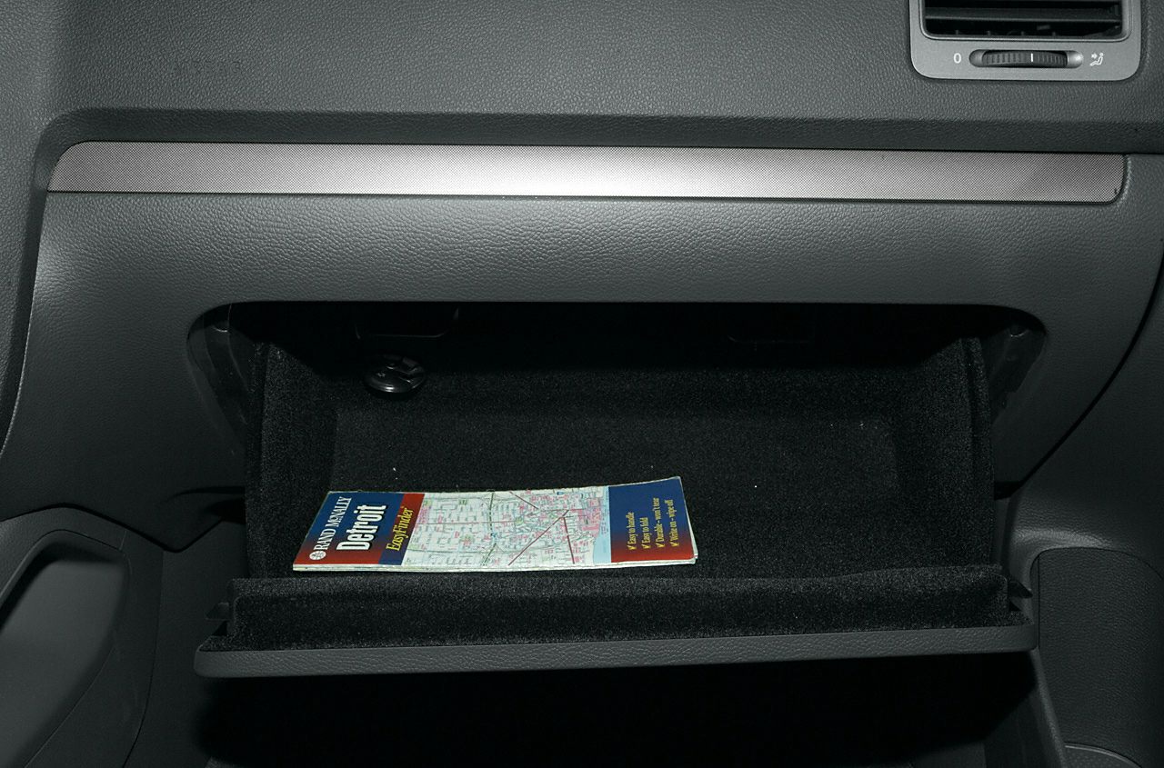 Open glove compartment with a map booklet inside
